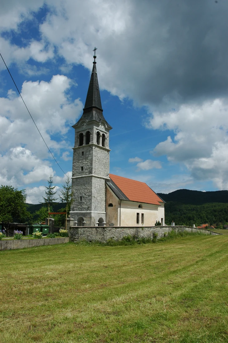 Cerkev sv. Nikolaja v Babnem Polju s kamnitim zvonikom in obzidanim pokopališčem